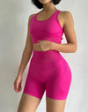 Person wearing a pink athletic outfit on a plain background