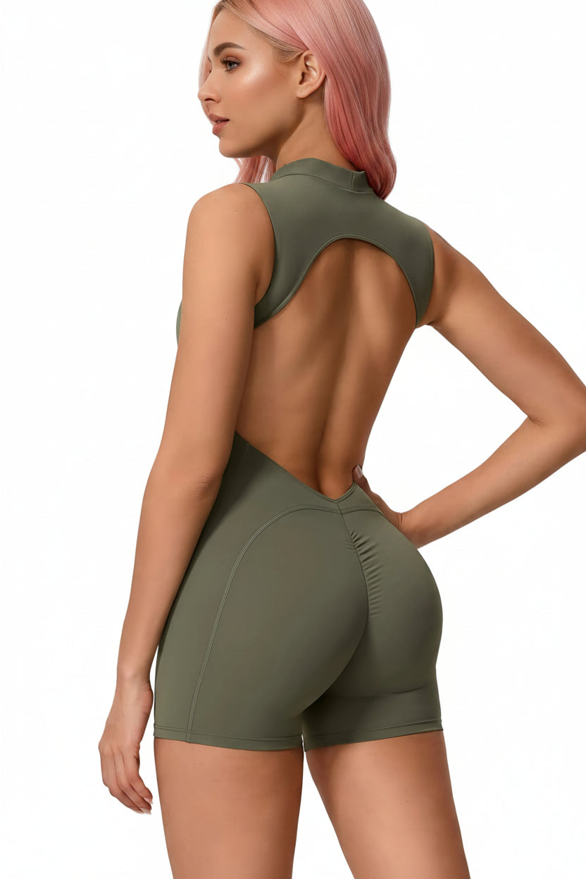 Woman wearing a green athletic outfit with an open back on a white background