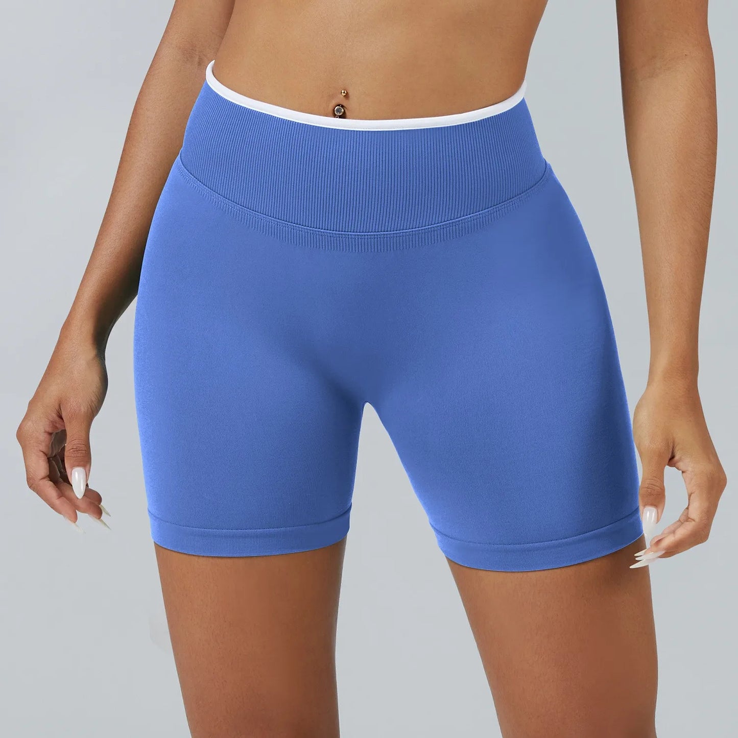 Blue athletic shorts worn by a person on a gray background