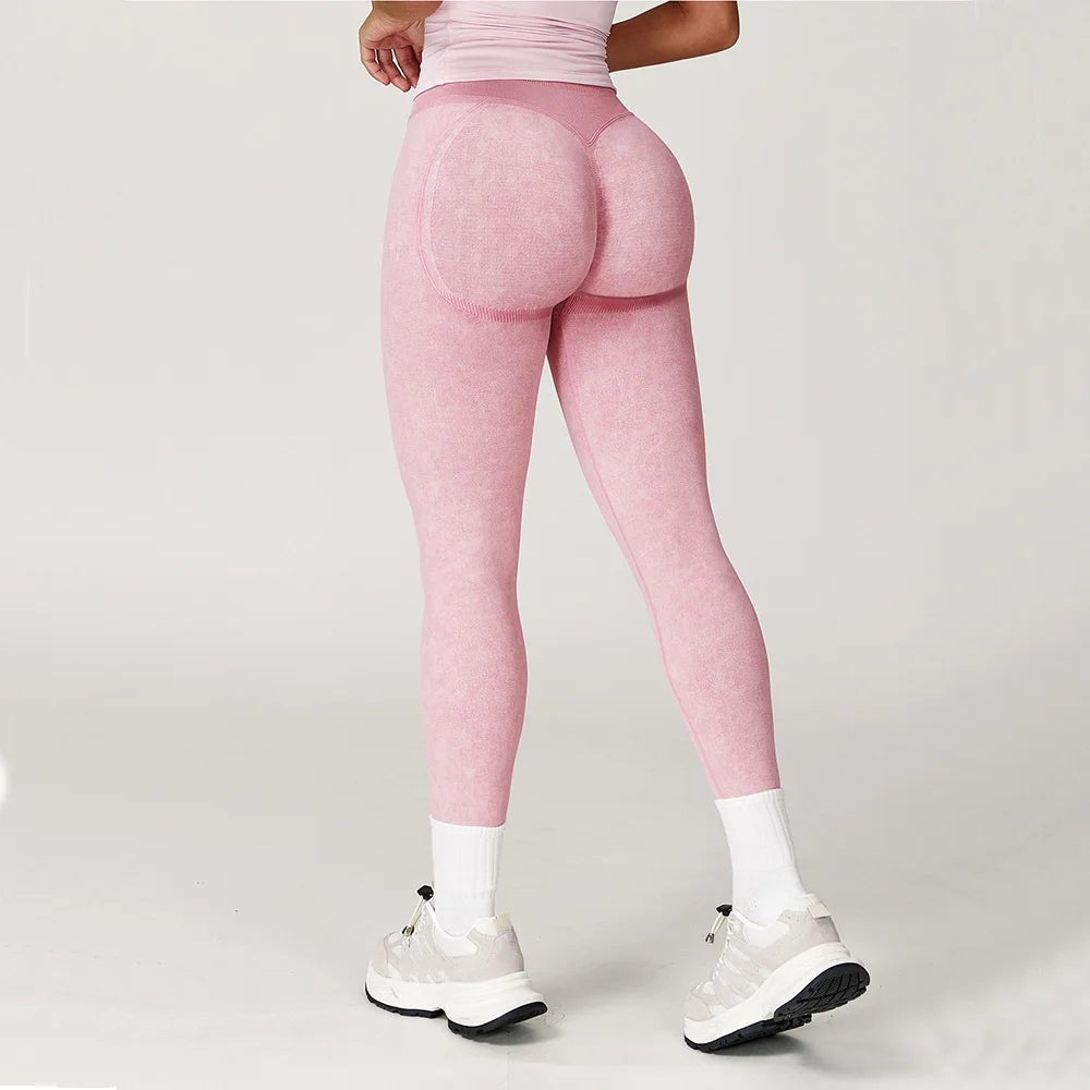 Person wearing pink leggings on a plain background