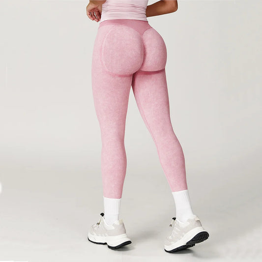 Person wearing pink leggings on a plain background