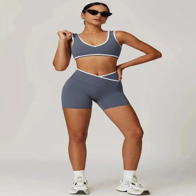 Woman in blue grey sports bra and shorts set. Front view