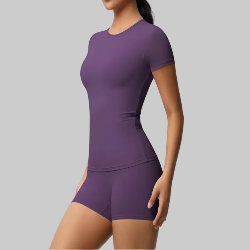 Person wearing a purple athletic outfit on a gray background